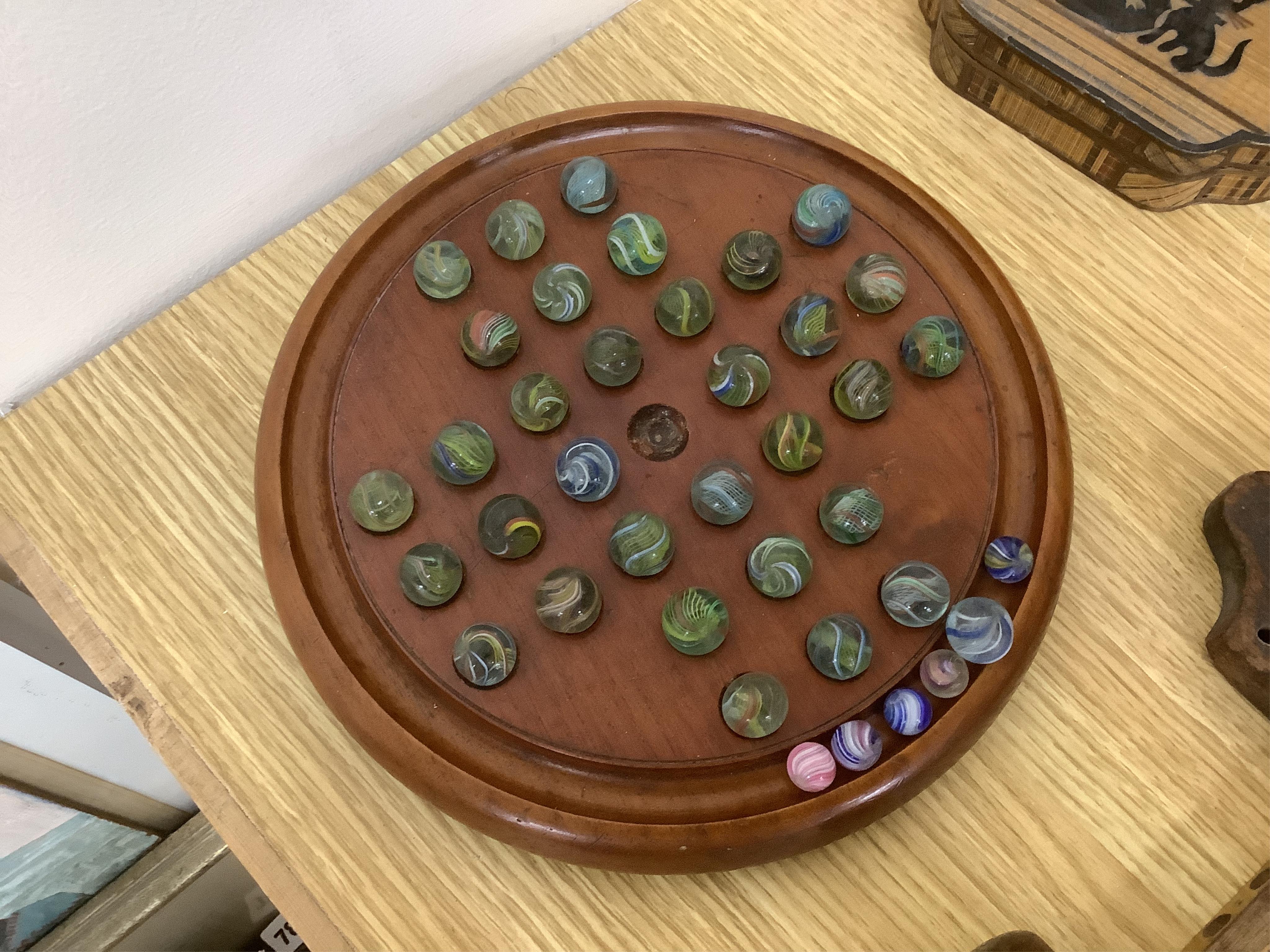 A group of wood items to include two cribbage boards, a mahogany solitaire board with marbles, a truncheon and an inlaid oval tray. etc., largest 60cm wide. Condition - varies, poor to fair